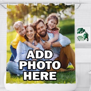 May include: A custom shower curtain featuring a printed photograph of a family sitting on green grass. The image displays a mother, father, a young boy in a yellow shirt, and a young girl in a striped shirt. The text ADD PHOTO HERE is printed.