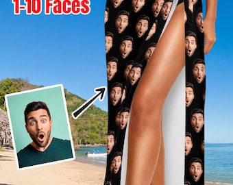 May include: A black sarong featuring a repeating pattern of a man's face with a surprised expression. The text "Custom 1-10 Faces" is printed in red and white on the left side. The garment is tied at the waist with a side slit.