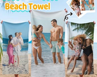 May include: Custom photo beach towels featuring family photos. The towels display images of families at the beach. The text "Custom Photo Beach Towel" is in yellow and blue. The towels are held up by people on a sandy beach.