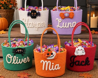 May include: Five round rope baskets in white, lavender, green, orange, and red, each featuring two handles and filled with candy. The baskets are personalized with the names Harper, Luna, Oliver, Mia, and Jack, and decorated with felt Halloween icons.