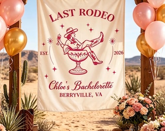 May include: A cream-colored fabric banner featuring dark pink text and graphics. The text reads LAST RODEO, EST. 2026, Chloe’s Bachelorette, and BERRYVILLE, VA. A central illustration shows a person in a cowboy hat and boots sitting in a large glass.