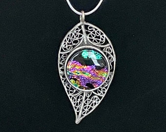 Dichroic glass pendant in a scrollwork leaf bezel.  Nickel free, lead free