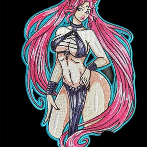 May include: Embroidered patch featuring a woman with long pink hair, wearing a black and white outfit with a dark purple skirt. The patch has a turquoise outline.