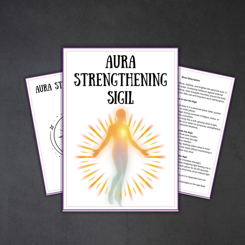 May include: Three white cards with purple borders and text. The central card reads "AURA STRENGTHENING SIGIL" with a glowing figure illustration. The other cards have text and a star design. The cards are on a dark gray surface.