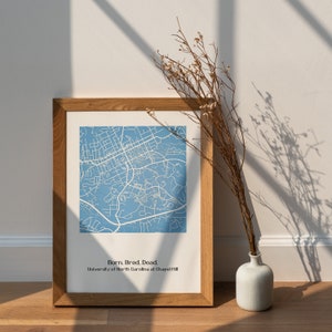 May include: A framed print of a blue map of the University of North Carolina at Chapel Hill campus. The text "Born. Bred. Dead." is printed below the map.