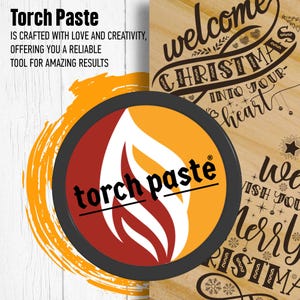 May include: A round container with a black lid and a red and yellow flame design. The container is labeled "torch paste" and has a registered trademark symbol. The background is a wooden surface with a Christmas-themed design.
