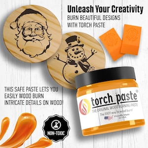 May include: A jar of orange wood burning paste with a label that reads "torch paste" and "The Original Wood Burning Paste". The label also includes the text "The Easy way to wood burn!" and "Proudly Made in USA". The jar is sitting on a white wooden surface with two wooden circles with designs burned into them. One circle has a snowman design and the other has a Santa Claus design. The jar is surrounded by a few drops of orange paste.