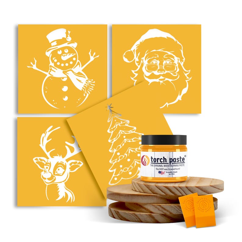 May include: Four yellow stencils with white Christmas designs: a snowman, Santa Claus, a reindeer, and a Christmas tree. A jar of woodburning paste is in the foreground.