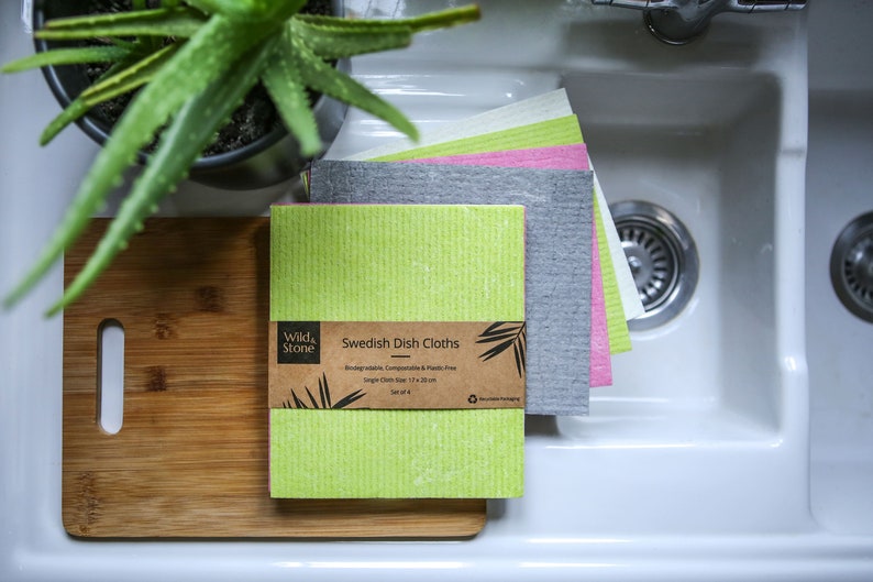 May include: A set of four Swedish dish cloths in green, gray, pink, and white. The cloths are made from biodegradable, compostable, and plastic-free materials. The packaging is made from recycled paper and is compostable. The cloths are 17 x 20 inches.