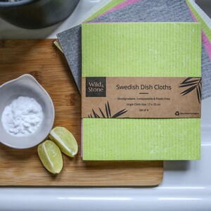 May include: Set of four green, gray, and pink Swedish dish cloths. The cloths are biodegradable, compostable, and plastic-free. Each cloth measures 17 x 20 inches. The packaging is made from recycled materials.