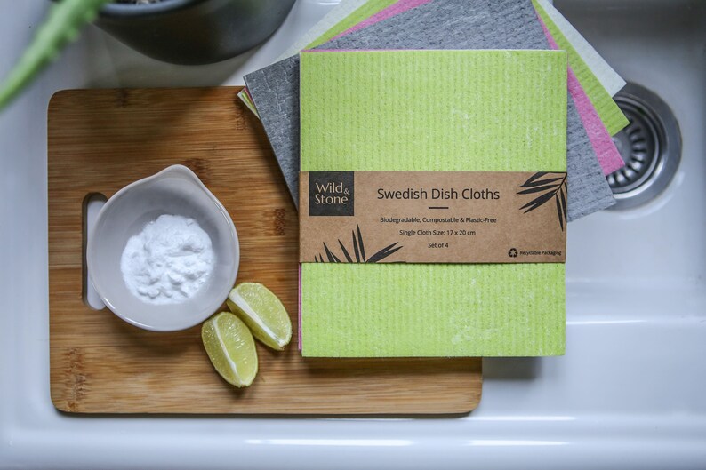 May include: Set of four green, gray, and pink Swedish dish cloths. The cloths are biodegradable, compostable, and plastic-free. Each cloth measures 17 x 20 inches. The packaging is made from recycled materials.