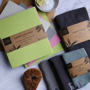 May include: A set of four green Swedish dish cloths, two gray hand towels, and a green dish cloth. The cloths are made of 100% organic cotton and are biodegradable, compostable, and plastic-free. The towels are 40 x 65 cm and the cloths are 24 x 24 cm.