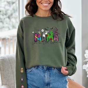 a woman wearing a green sweatshirt with the word mama on it