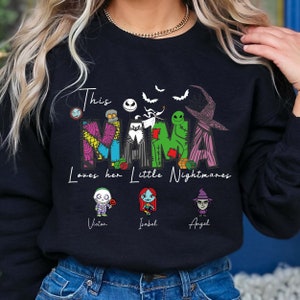 May include: Black sweatshirt with a graphic of the characters from the Nightmare Before Christmas movie. The text "This Mama Loves her Little Nightmares" is printed on the shirt. The names "Victor", "Isabel", and "Angel" are printed below the characters.