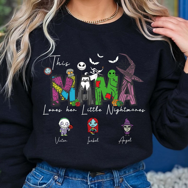 May include: Black sweatshirt with a graphic of the characters from the Nightmare Before Christmas movie. The text "This Mama Loves her Little Nightmares" is printed on the shirt. The names "Victor", "Isabel", and "Angel" are printed below the characters.