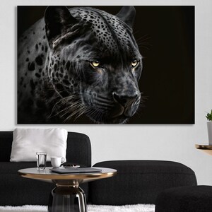 May include: A black and white canvas print featuring a close-up of a black jaguar's face. The jaguar has yellow eyes and a detailed coat pattern. The artwork is set against a dark background, creating a dramatic effect.