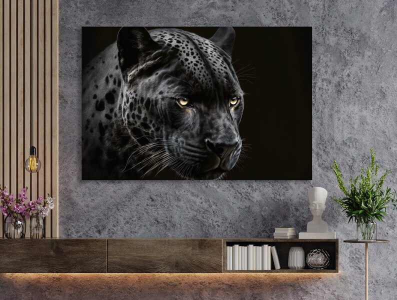 May include: A canvas print featuring a close-up of a black jaguar's face. The jaguar has yellow eyes and a black coat with dark spots. The artwork is displayed on a wall above a wooden cabinet.