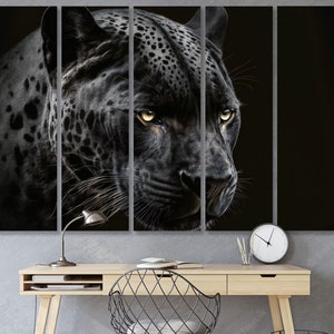 May include: A five-panel canvas art print featuring a close-up of a black panther's face. The panther has yellow eyes and a black coat with dark spots. The artwork is displayed above a wooden desk with a lamp and clock.