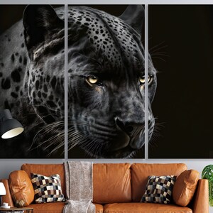 May include: A triptych canvas print featuring a close-up of a black panther's face. The panther's fur is detailed with spots, and its yellow eyes are focused. The artwork is set against a dark background, creating a dramatic effect.