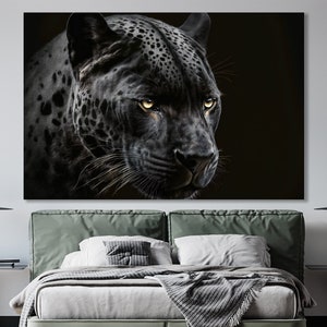 May include: A large canvas print featuring a detailed portrait of a black panther. The panther's face is in sharp focus, with striking yellow eyes and visible whiskers. The artwork is set against a dark background, emphasizing the animal's features.