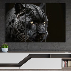 May include: A triptych canvas print featuring a close-up of a black jaguar's face. The jaguar's fur is a dark gray with black spots, and its eyes are a bright yellow. The background is a solid black, creating a dramatic contrast.