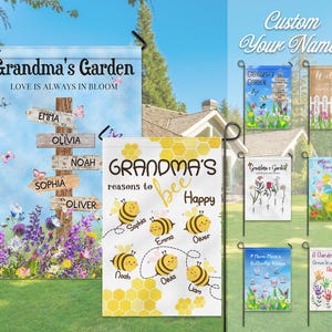 May include: A collection of personalized garden flags with various designs. One flag reads "Grandma's Garden" with names on directional signs. Another says "Grandma's reasons to bee happy" with bee illustrations and names. Other flags feature floral and garden themes.