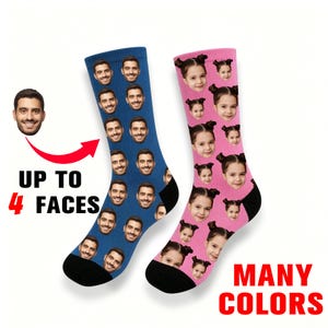 May include: A pair of crew socks, one blue and one pink, featuring a repeating pattern of a person's face. The text UP TO 4 FACES and MANY COLORS is printed in black and red. The socks have black cuffs, heels, and toes, with a white background.