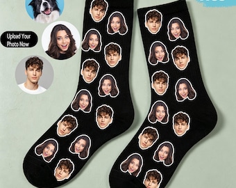 May include: A pair of black crew socks featuring a repeating pattern of various human faces printed across the fabric. The socks have a ribbed cuff at the top and are displayed alongside circular photo examples of a dog and two people.