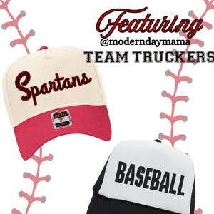 May include: Two trucker hats, one white with black mesh and the text "BASEBALL" in black, and one cream with a pink brim and the text "Spartans" in red. The hats are on a red and white baseball stitch background.