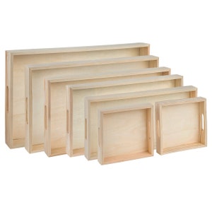 May include: Set of six wooden trays in various sizes, all made of natural wood with a light brown finish. The trays have a simple rectangular shape and are perfect for serving or displaying items.