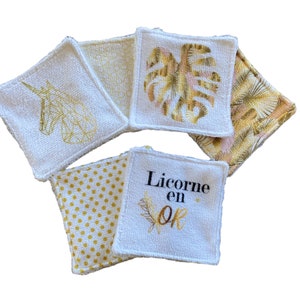 Puede incluir: Seis almohadillas de algod&oacute;n blanco para desmaquillar con bordados dorados. Los dise&ntilde;os incluyen un unicornio, lunares, una hoja tropical y el texto "Licorne en or".