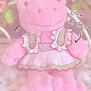 May include: A pink plush frog wearing a crocheted daisy skirt with a white lace trim. The skirt is labeled "Crochet Daisy Skirt!" and the image is labeled "Pattern only!"