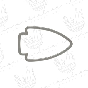May include: A silver metal cookie cutter shaped like an arrowhead. The cutter is designed to cut out cookies in the shape of an arrowhead.