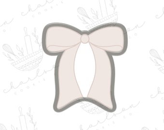 May include: A light pink bow cookie cutter with a simple design. The cutter is made of metal and has a smooth finish.