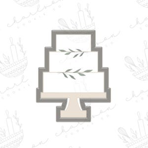 Puede incluir: Un cortador de galletas de metal gris en forma de pastel de boda de tres niveles con diseños simples de hojas en cada nivel.