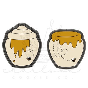 May include: Two cookie cutters shaped like honey pots with a bee and a heart design. The cutters are made of metal and have a gray finish.