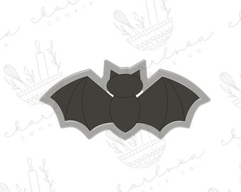 Könnte beinhalten: Ein schwarzer Fledermaus-Ausstecher mit einfachem Design. Der Ausstecher ist aus Metall und hat eine glatte, glänzende Oberfläche.
