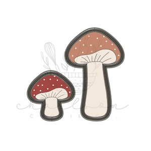 May include: Two red and white mushroom cookie cutters. The larger cutter is brown with white dots and the smaller cutter is red with white dots.