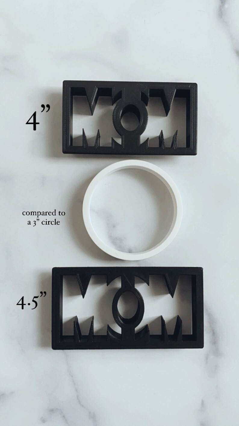 May include: Two black plastic cookie cutters shaped like the word "MOM". The top cutter is 4 inches wide and the bottom cutter is 4.5 inches wide. The cutters are shown next to a white plastic circle, which is 3 inches in diameter.