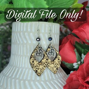 May include: A pair of wooden earrings with a floral pattern and a silver heart charm. The earrings are hanging from silver hooks with black beads.
