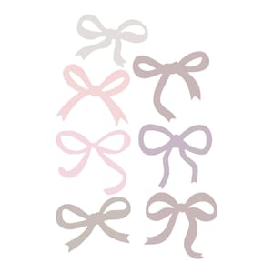 May include: Set of seven pastel-colored bows in various shades of pink, purple, and gray. The bows are arranged in a vertical line, with the lightest color at the top and the darkest color at the bottom.