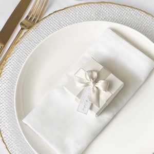 White wedding favour box with gold table decor.