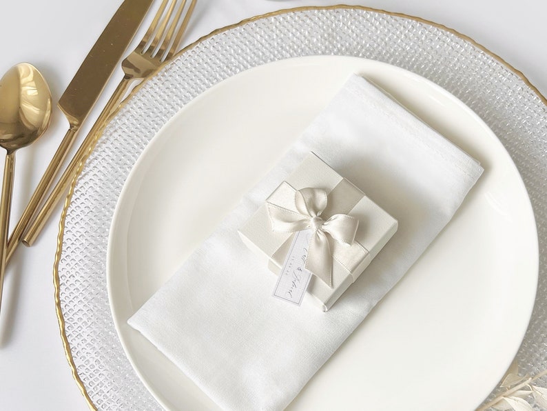 White wedding favour box with gold table decor.