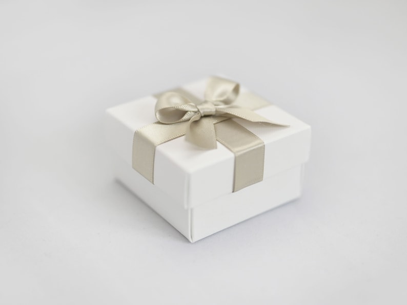 White wedding favour box with hint of green ribbon.