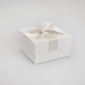 White wedding favour box with ivory ribbon.
