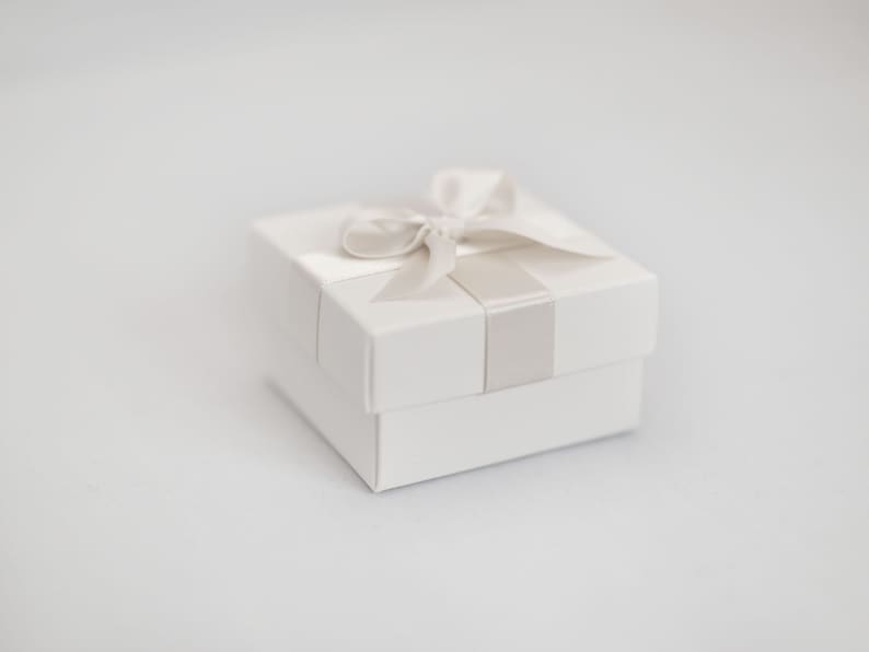 White wedding favour box with ivory ribbon.