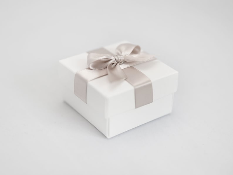 White wedding favour box with taupe ribbon.