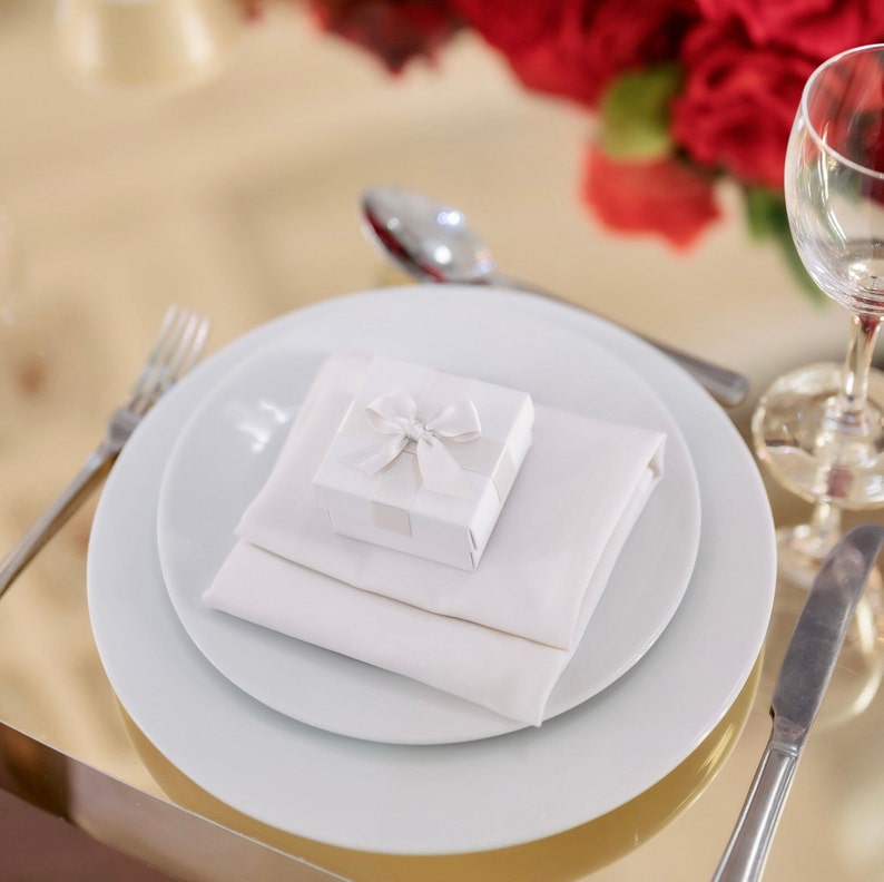 White wedding favour box with ivory ribbon with table decor.