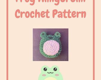 May include: A crochet pattern for a frog amigurumi. The image shows a finished green and white frog amigurumi, along with a cartoon frog illustration. The text "Frog Amigurumi Crochet Pattern" is displayed in pink.