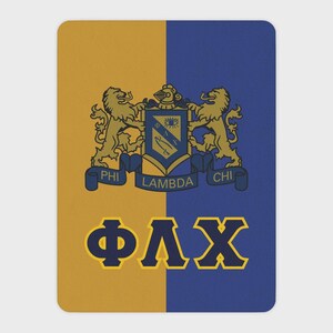 May include: A rectangular blanket featuring a vertical split design with gold on the left and blue on the right. The center displays a crest with two lions, a shield with an eye and sword, and the text PHI LAMBDA CHI. Below, the Greek letters ΦΛΧ appear.